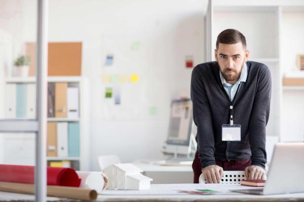 Serious office worker looking at